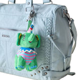 Four colorful, retro-style plush animal bag charms dressed as circus clowns by artist So Lazo, shown hanging together from a metal clip with a logo ribbon strap
