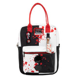 Reversible and convertible horror movie Terrifier 2 tote bag showcasing a split black-and-white design with red blood splatters, a bloody meat cleaver bag charm, and an Art the Clown charm