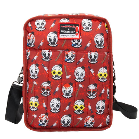 Reversible and convertible horror movie Terrifier 2 tote bag showcasing a split black-and-white design with red blood splatters, a bloody meat cleaver bag charm, and an Art the Clown charm