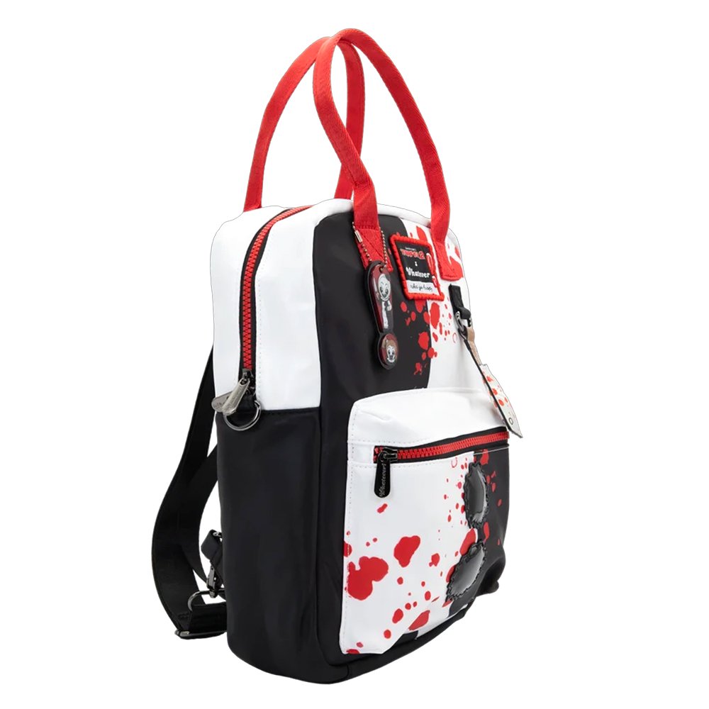 Reversible and convertible horror movie Terrifier 2 tote bag showcasing a split black-and-white design with red blood splatters, a bloody meat cleaver bag charm, and an Art the Clown charm