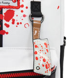 Reversible and convertible horror movie Terrifier 2 tote bag showcasing a split black-and-white design with red blood splatters, a bloody meat cleaver bag charm, and an Art the Clown charm