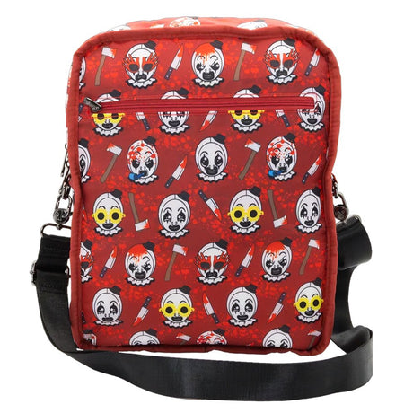 Reversible and convertible horror movie Terrifier 2 tote bag showcasing a split black-and-white design with red blood splatters, a bloody meat cleaver bag charm, and an Art the Clown charm