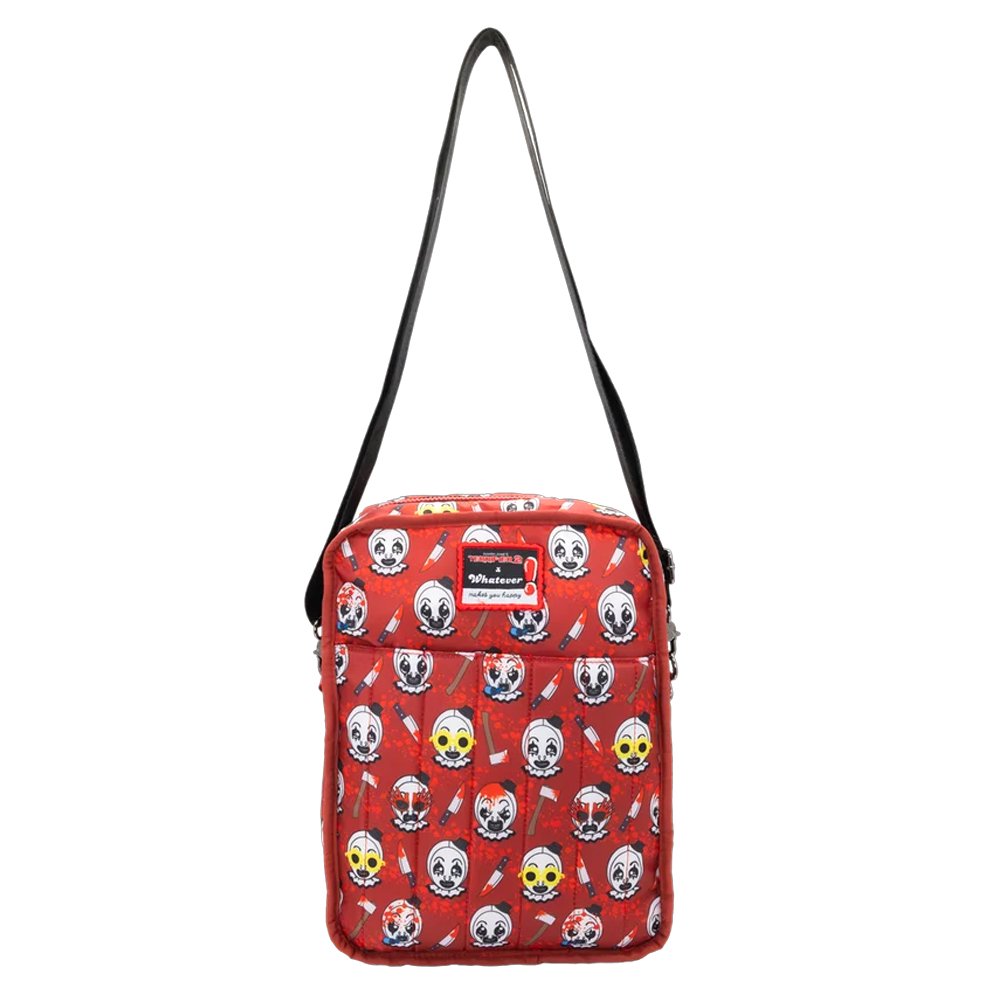 Reversible and convertible horror movie Terrifier 2 tote bag showcasing a split black-and-white design with red blood splatters, a bloody meat cleaver bag charm, and an Art the Clown charm
