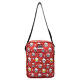 Reversible and convertible horror movie Terrifier 2 tote bag showcasing a split black-and-white design with red blood splatters, a bloody meat cleaver bag charm, and an Art the Clown charm