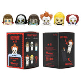 Six Warner Bros horror mystery blind box phone buddy mini figures lined up featuring Annabelle, The Nun, Regan, Pennywise, David, one secret Chase style