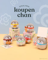 An Official Spiralcute licensed Koupen Chan surprise plush blind box unboxing scene displaying six miniature penguin stuffed toys with different sweets next to their opened pink packaging boxes, designed for adult collectors seeking a workplace healing experience.