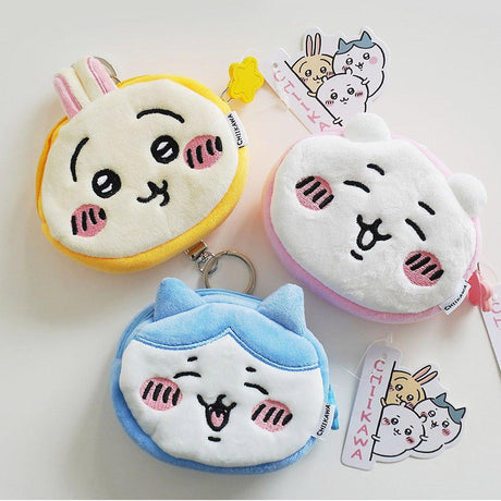 Three cute Chiikawa, Hachiware and Usagi coin purses with keychains on a white background