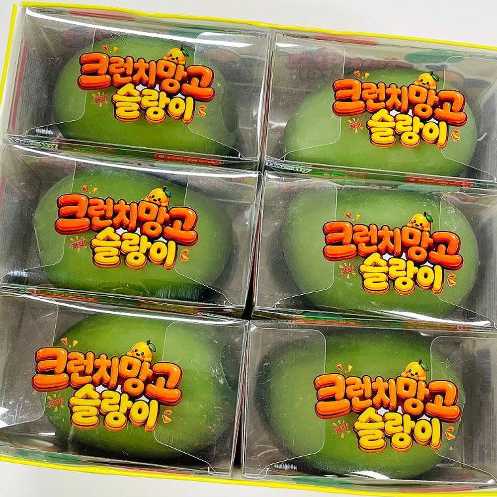 Display box set of 6 Crunchy Mango Squishy Toys individually packaged in clear plastic boxes with Korean text reading Crunchy Mango Slime, featuring green color-changing mango fidgets for stress relief and anxiety relief, ideal party favor goodie bag filler, Christmas stocking stuffer, and holiday gift set