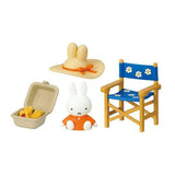 Toy set with a Miffy figure, hat, suitcase, and chair on a white background