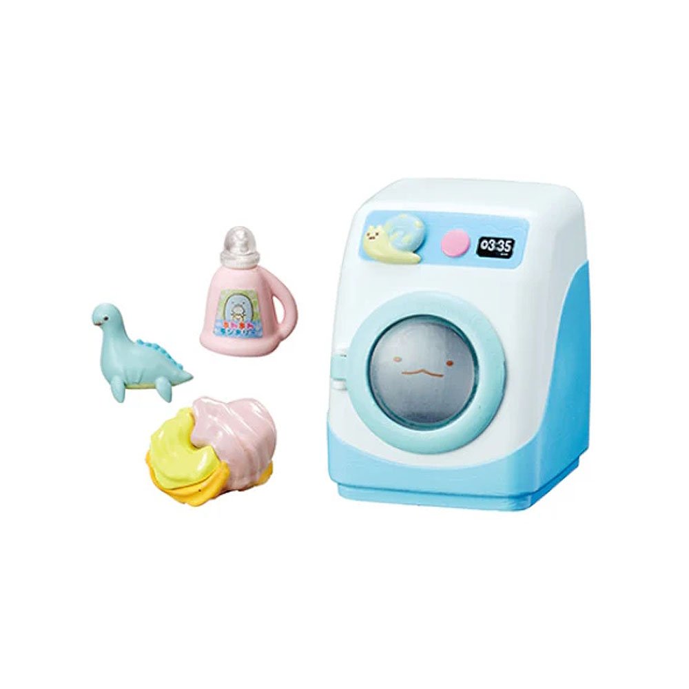 Sumikko oy washing machine with plush toy inside, accompanied by a bottle and seal toy on a white background