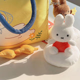 Plush keychain of Miffy character in an orange outfit sitting on the cloud
