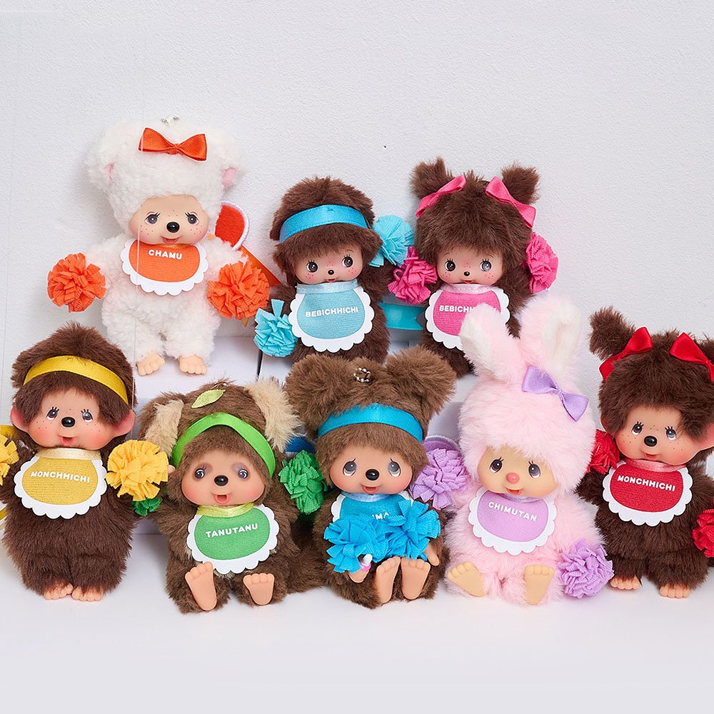 Collection of colorful Monchhich small dolls Plushies with colorful outfits and accessories on a white background