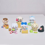 Set of small Chiikawa figurines with various poses and accessories on a white surface.