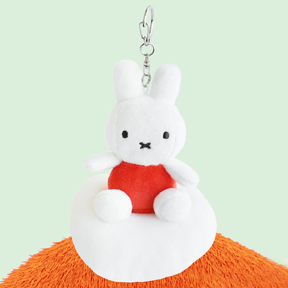 Plush keychain of Miffy character in an orange outfit sitting on the cloud