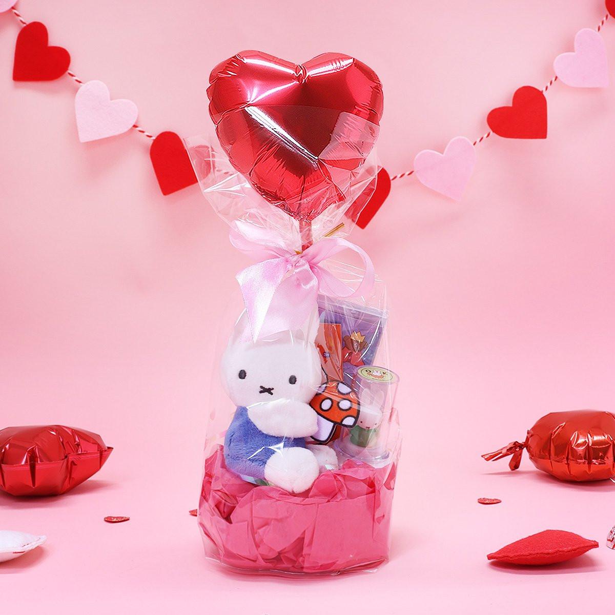 Official Miffy Valentine's Day Plush Gift Set in a clear ribbon package with a heart balloon. Includes a small blue miffy holding a mushroom and a collectible figure stamp, sticker, and notepad perfect for Kawaii aesthetic Valentine's Day gift ideas