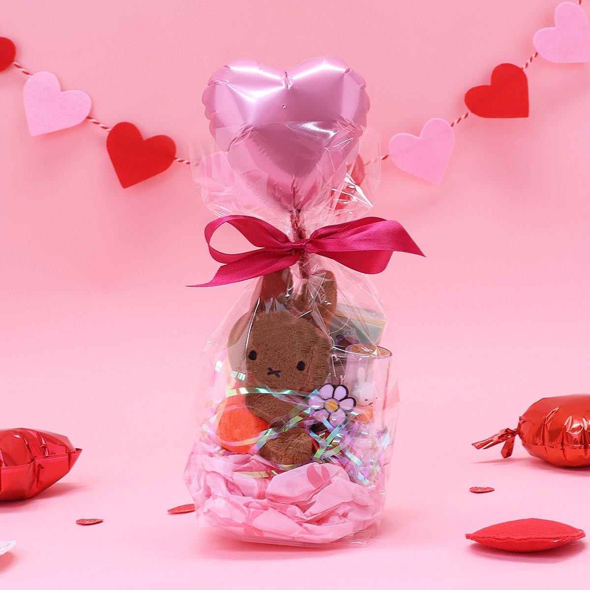 Official Miffy Valentine's Day Plush Gift Set in a clear ribbon package with a heart balloon. Includes a small brown miffy holding a flower and a collectible figure stamp, sticker, and notepad perfect for Kawaii aesthetic Valentine's Day gift ideas
