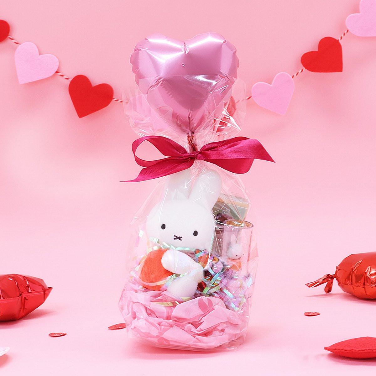 Official Miffy Valentine's Day Plush Gift Set in a clear ribbon package with a heart balloon. Includes a small red miffy holding a flower and a collectible figure stamp, sticker, and notepad perfect for Kawaii aesthetic Valentine's Day gift ideas