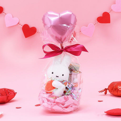 Official Miffy Valentine's Day Plush Gift Set in a clear ribbon package with a heart balloon. Includes a small red miffy holding a flower and a collectible figure stamp, sticker, and notepad perfect for Kawaii aesthetic Valentine's Day gift ideas