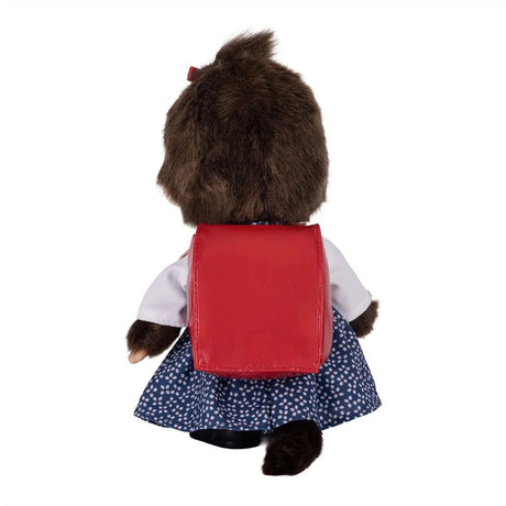 Back view of Sekiguchi Monchhichi Japanese School Bag Girl 8 Inch Plush Doll showing red japanese randoseru school backpack strapped over blue floral dress and brown plush tail, perfect stocking stuffer and Christmas gift idea