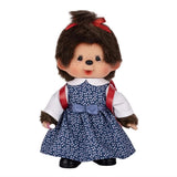 Front view of Sekiguchi Monchhichi Japanese School Bag Girl 8 Inch Plush Doll wearing blue floral pinafore dress over white shirt, red hair bow, and red Randoseru backpack, ideal holiday season collectible gift