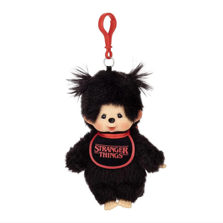 Front view of Officially Licensed Sekiguchi Monchhichi x Stranger Things Black Girl Bib Clip-On Mascot Plush Keychain in black fur featuring red Stranger Things logo bib, twin pigtails, and red clip hook, perfect Christmas gift and bag charm accessory