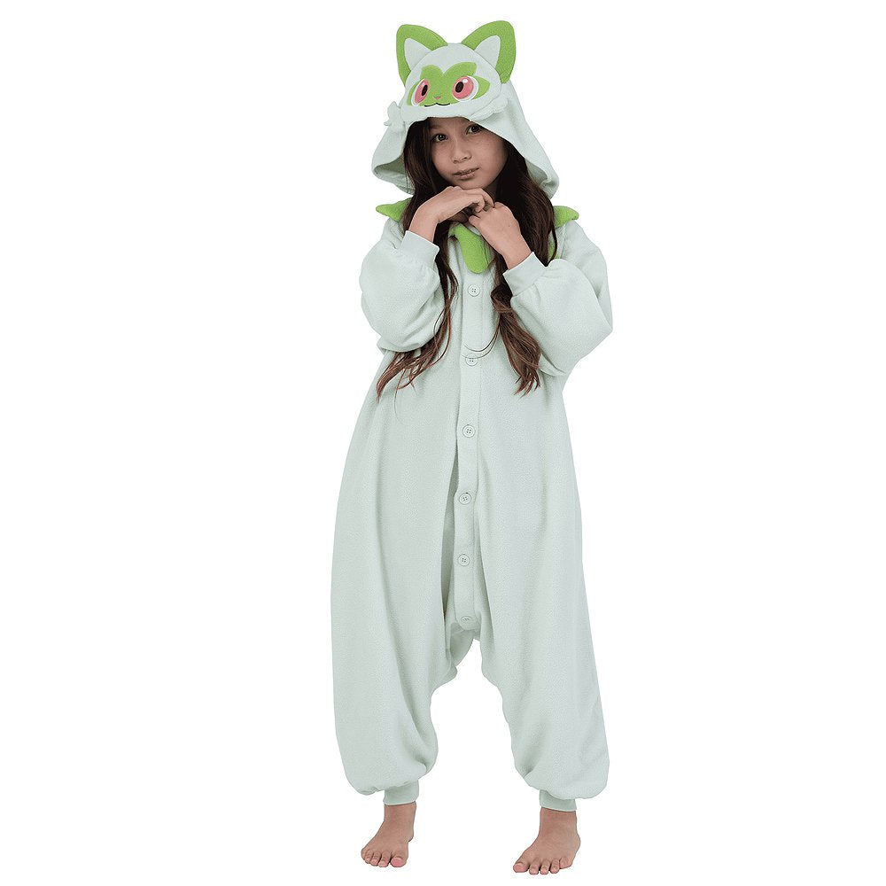 Official Pokémon Sprigatito Kids Costume Kigurumi Onesie Jumpsuit worn by a smiling young model holding the hooded ears. Features a soft pale mint-green fleece body, green leaf collar, and a Sprigatito face hood with pink eyes. Ideal for kids' Halloween costumes, cosplay party suits, sleepovers, and holiday gifts