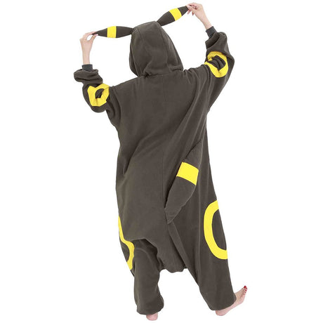 Official Pokémon Umbreon Costume Kigurumi Onesie Jumpsuit worn by a model holding the hooded ears. Features a soft black fleece body with yellow oval patterns and red character eyes. An ideal cosplay outfit for Halloween costumes, cozy sleepover nights, and year-end holiday party loungewear for adult Pokémon fans.