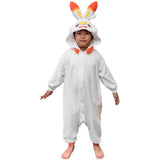 Young boy standing in Pokémon Scorbunny Kids Fleece Kigurumi Onesie Jumpsuit showing loose comfortable fit, ultra-warm white fleece children's Halloween party costume, winter pajamas and loungewear, ideal holiday present and warm Christmas sleepwear gift for kids