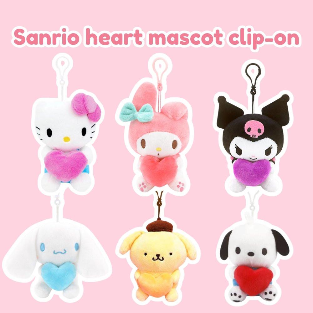 Sanrio heart mascot clip-on plush collection featuring Hello Kitty, My Melody, Kuromi, Cinnamoroll, Pompompurin, and Pochacco. Small kawaii plush keychains holding colorful hearts for Valentine's Day backpack accessories or gift toppers