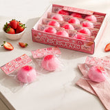 Retail display box and individually packaged pink Strawberry Rice Cake Bread Squishy Toys next to fresh strawberries, featuring stretchy mochi-like texture for stress relief, ideal party favor goodie bag filler and Christmas stocking stuffer gift