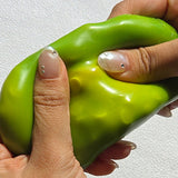 Squeezing open a green Sugar Mango Crunch Slime showing soft white stretchy slime filled with colorful crunch beads and yellow toppings inside, perfect Christmas gift and stress relief sensory toy