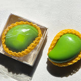 Sugar Mango Crunch Slime packaged in a clear square gift box with yellow fruit protective net mesh, looking like a real green mango, ideal holiday stocking stuffer and fun fidget present