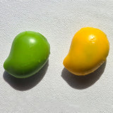 Hands squeezing a green Crunchy Mango Squishy Toy producing crisp ASMR crackle sound, featuring flexible TPR shell, color-changing chameleon effect, perfect Christmas gift and holiday stocking stuffer idea