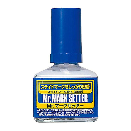 Bottle of Mr. Mark Setter with blue cap and label on a white background. Mark setter Use Mr. Mark Softer and Mr. Mark Setter to apply dry transfer decals. 