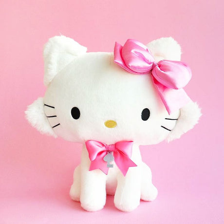 Sanrio Charmmy Kitty plush  toy resembling a white cat with a large pink bow on its head and additional pink bows around its neck.